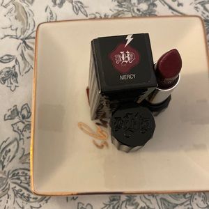 a neutral-toned, dark plum with a cream finish. It is a permanent lipstick